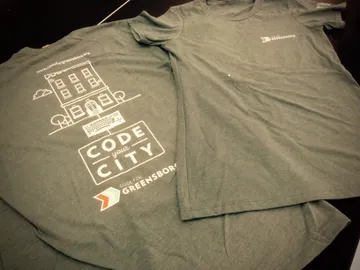 Grey t-shirt with Code City and Code for Greensboro logo